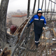 A worker stands on the Shukhov tower's rusted surface.